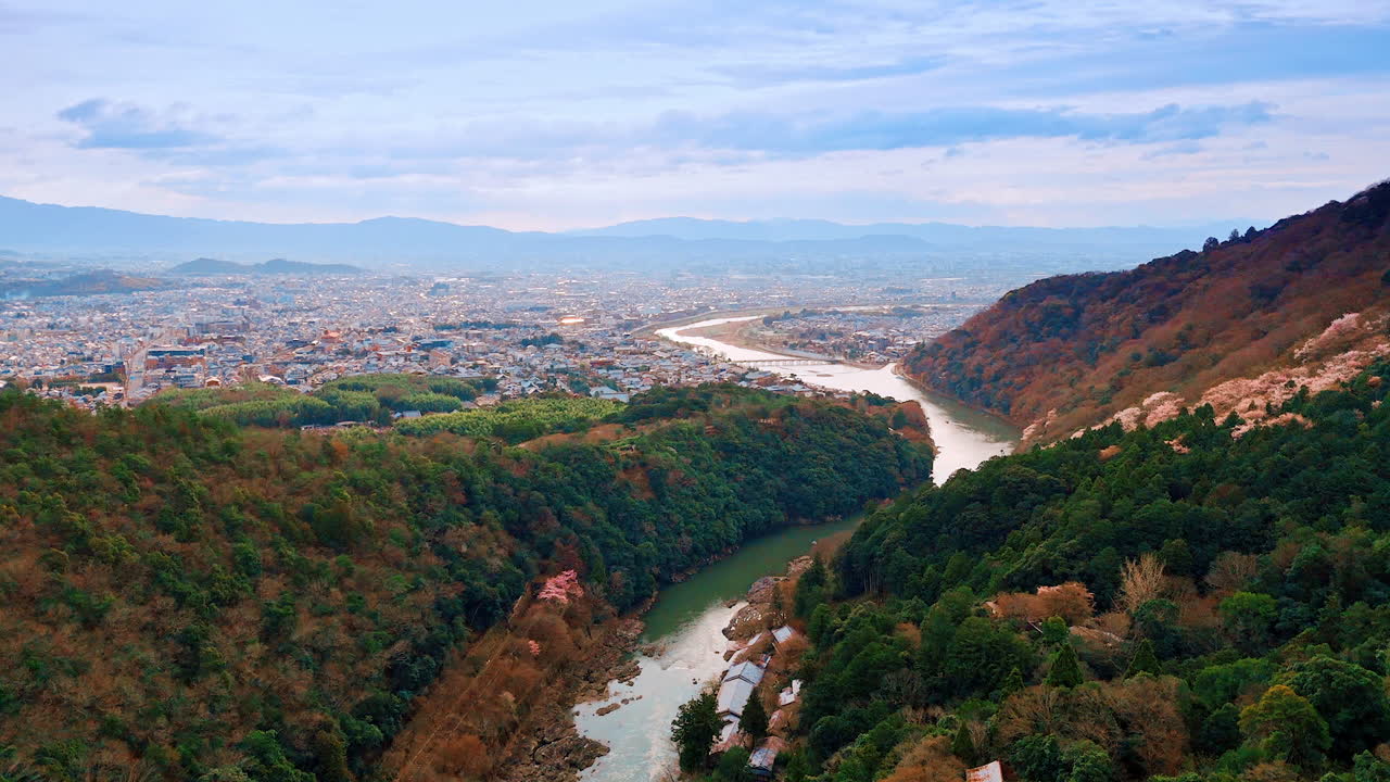Mountains and river at the outskirts of Kyoto, Japan. Vast cityscape with mountain range at backdrop. Aerial view.