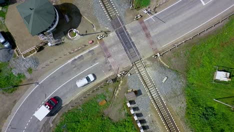 aerial view of train crossing with cars and trucks