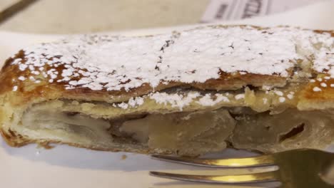 close up shot of cake with a fork, handheld