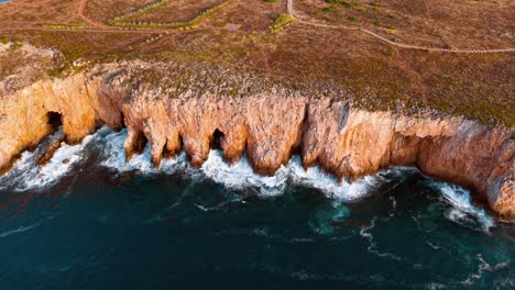 stunning aerial view of coastal cliffs in portugal during sunset