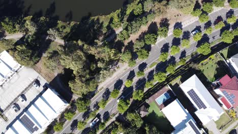 Aerial-view-of-a-divided-road-in-a-residential-suburb-with-light-traffic-in-Australia