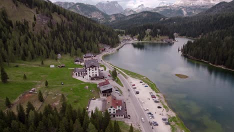 lake misurina aerial over restaurants toward mountains, dolomites