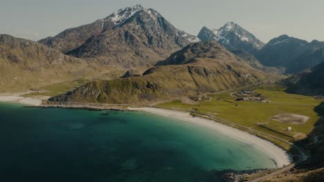 Aerial-drone-shot-tilting-and-revealing-secret-sandy-beach-in-Lofoten-Islands-in-Norway