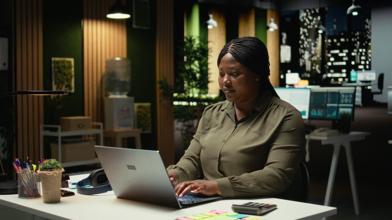 African american woman typing essential information on laptop