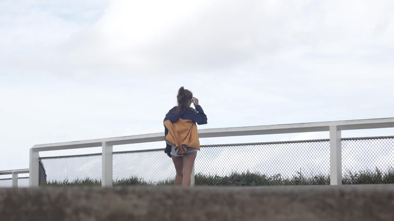 Woman looking at a scenic view from a viewpoint