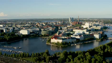 slow aerial pan of the helsinki waterfront reflecting on the water below at sunset, finland