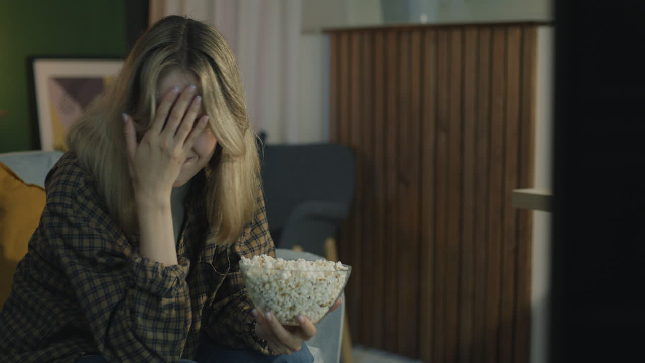 Woman Watching TV Disappointedly
