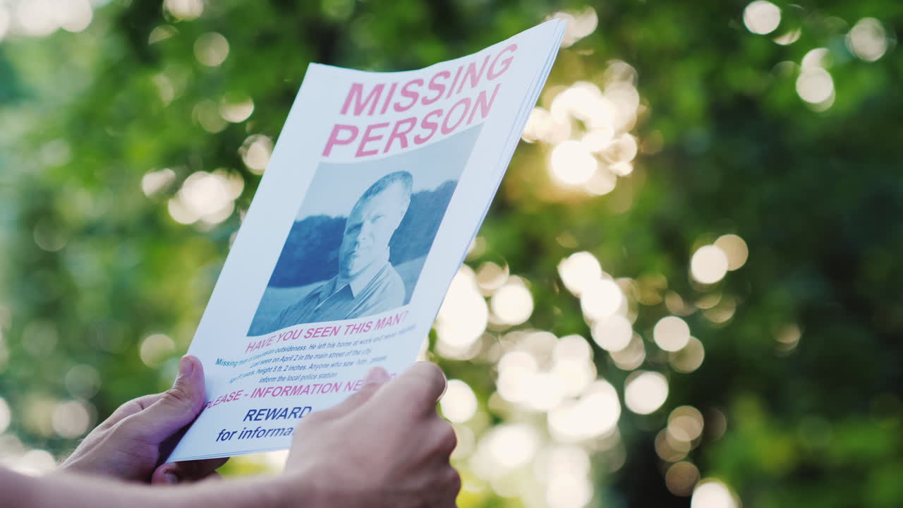 Man Holding A Flyer With The Announcement Of The Missing Man