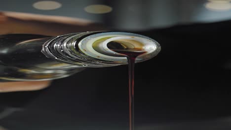 dark sauce pouring from bottle