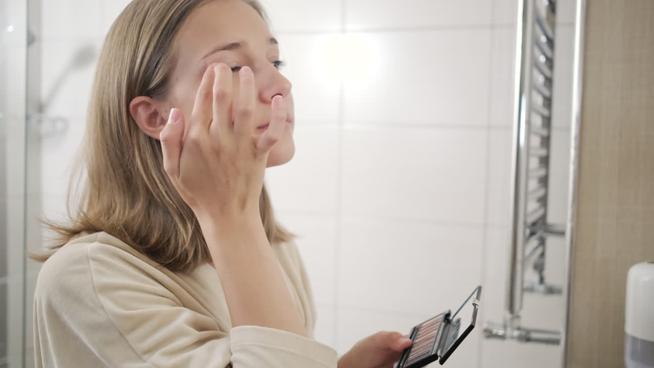 십대 가 화장실 에서 메이크업 을 하고 있다