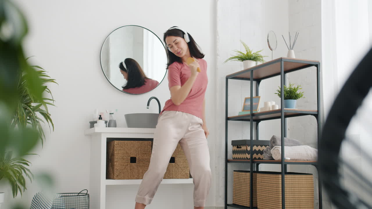 Woman Dancing and Singing in Bathroom