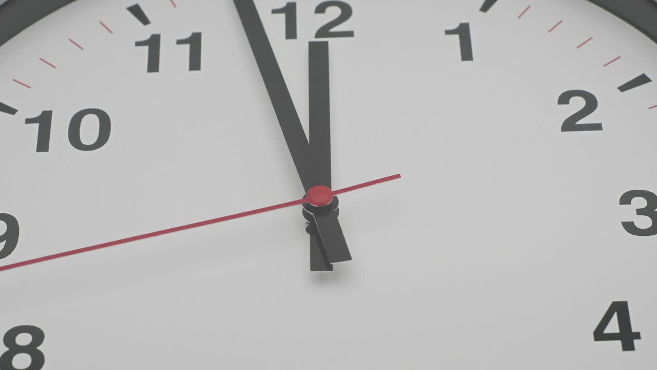 Time-lapse gray clock with black arrows shows motion the time speed up from 11.00 to 12.00, How time flies concept.