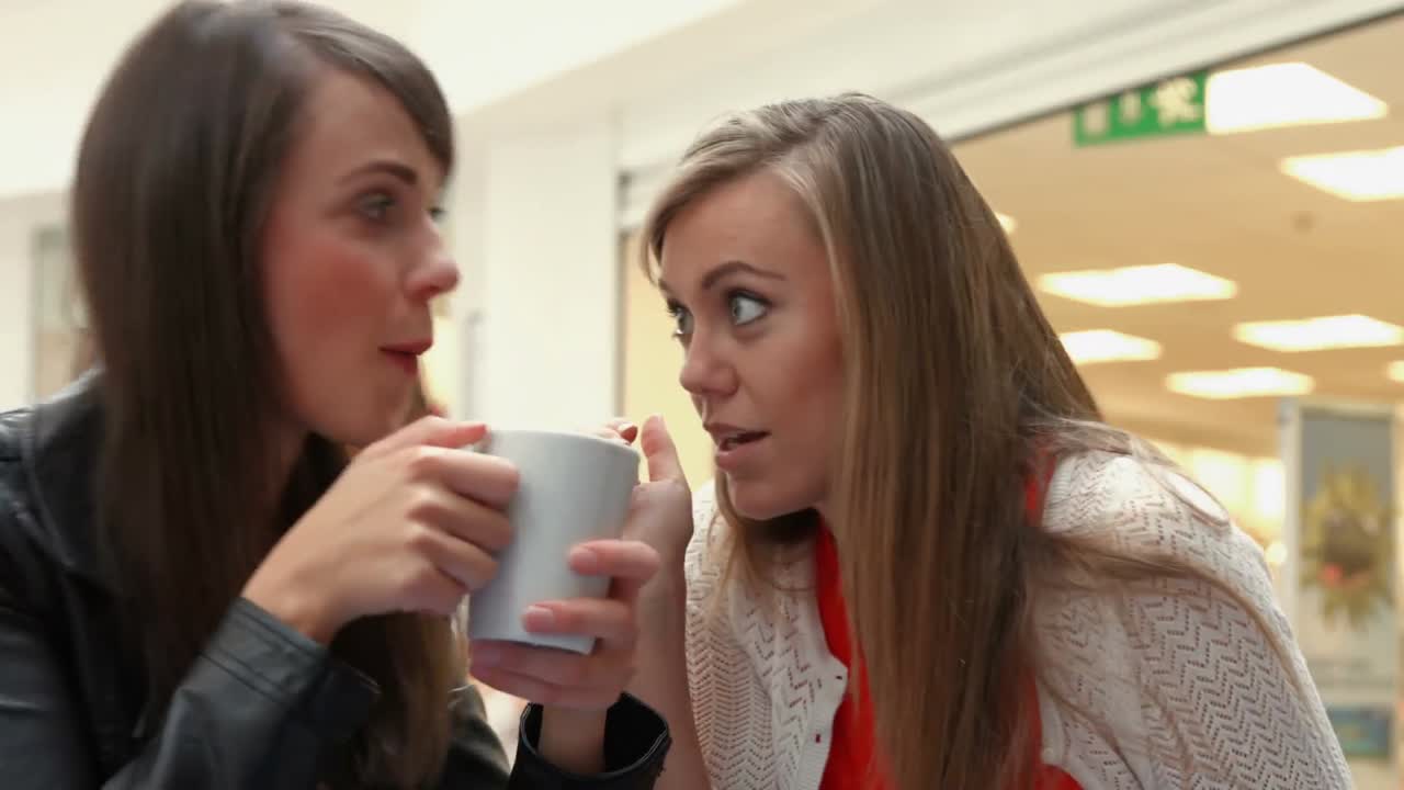Happy friends having coffee together and gossiping