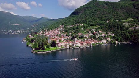 static aerial landscape of boat cruising past torno, lake como, italy