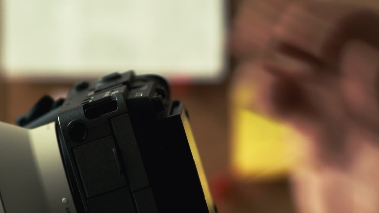 Spy using binoculars and taking photos of crime evidence, interior view, board in background, side face closeup view