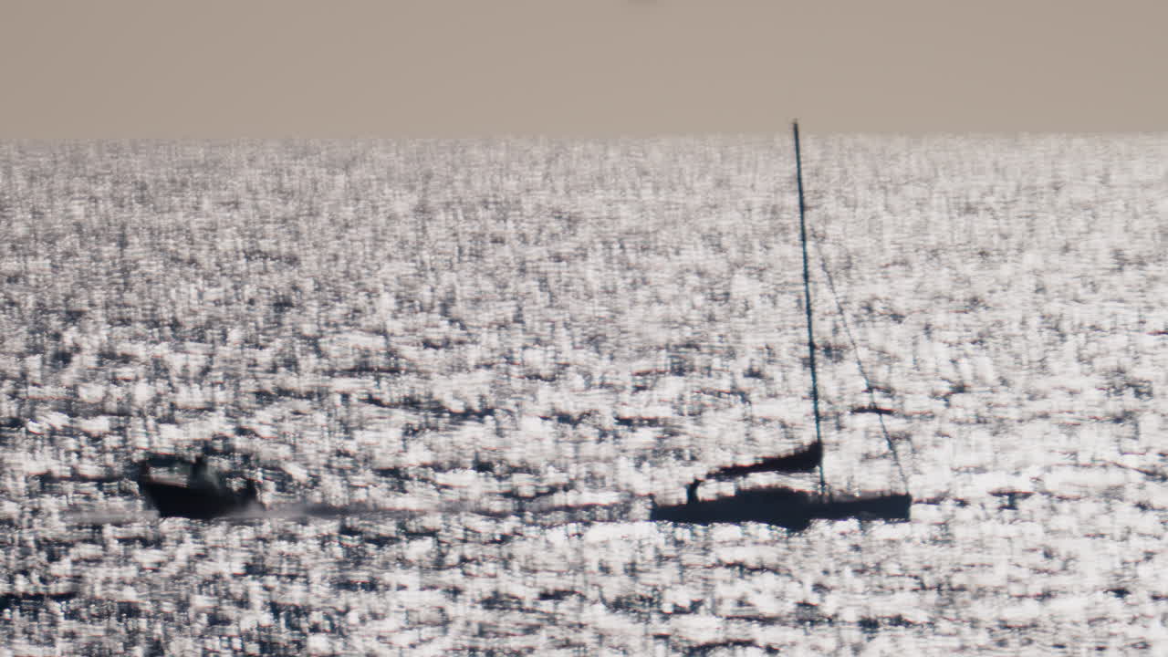 Blurred view of boats moving on the sea on a sunny day