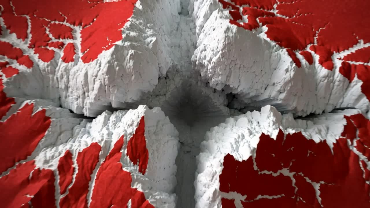 La giuntura si allarga, la superficie rossa si lacera, si scolla e si arriccia, rivelando un'anima bianca mentre la telecamera si muove.