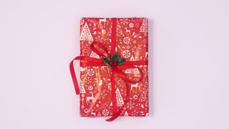 christmas gift with red ribbon rotate on white theme. stop motion