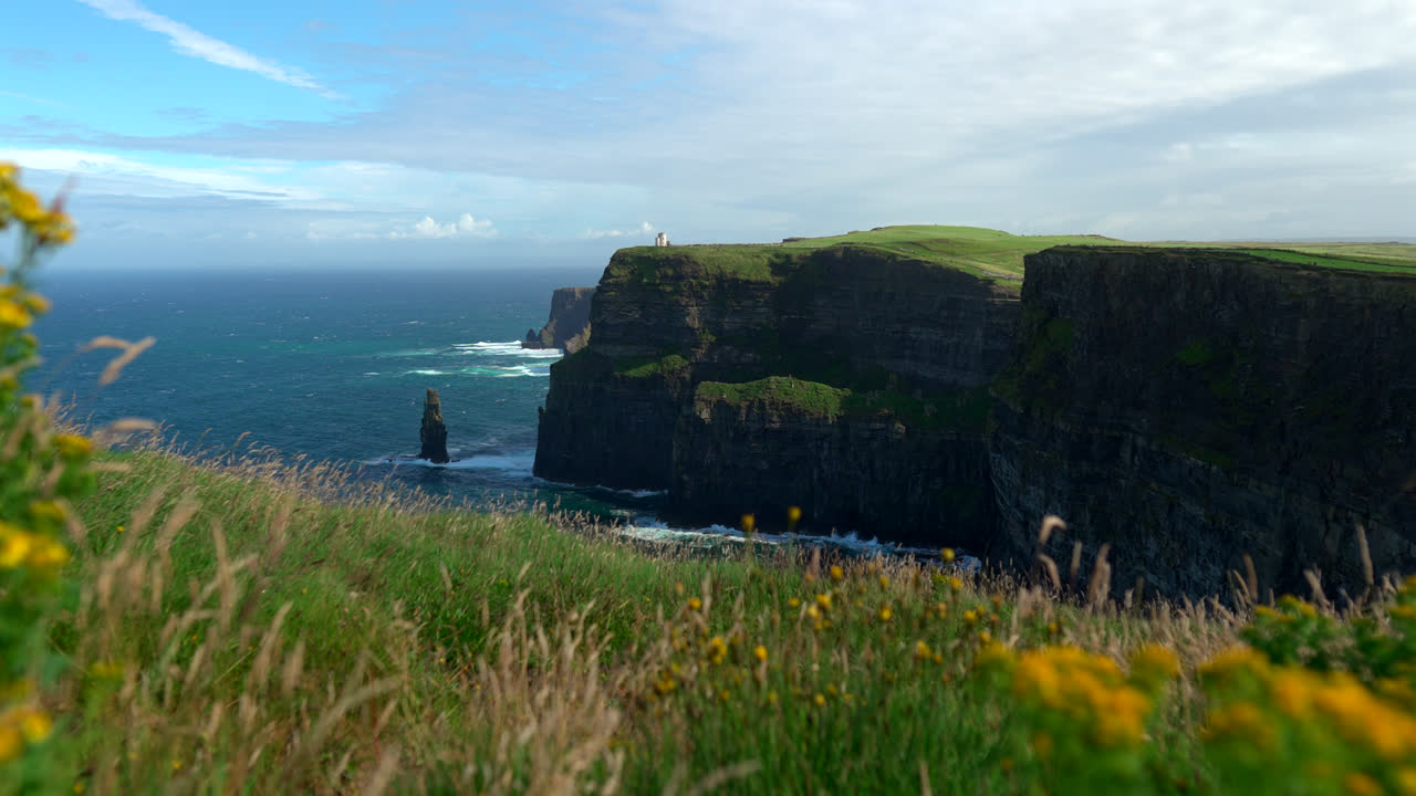 Massive cliffs stretch along the Atlantic coast, their steep edges carved by wind and waves. The Cliffs of Moher stand as one of Ireland’s most breathtaking natural landmarks.