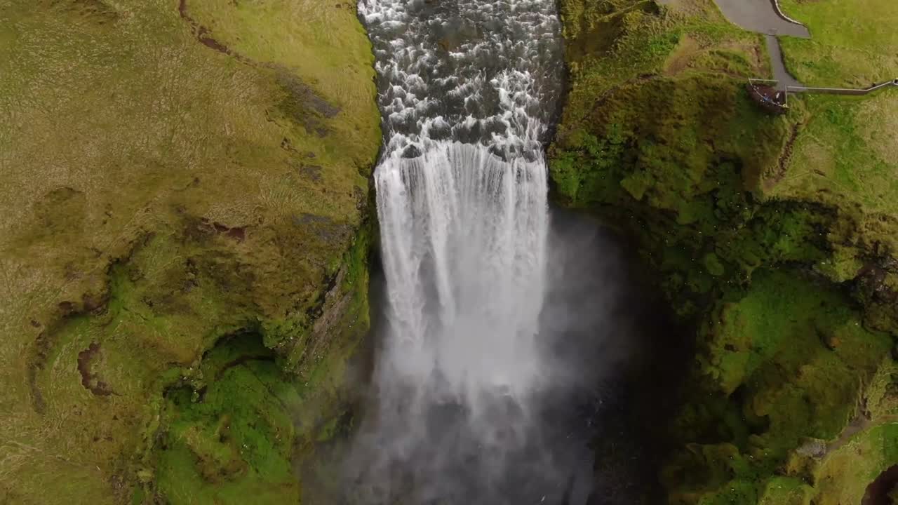 Majestic waterfall cascading in Iceland during bright daylight