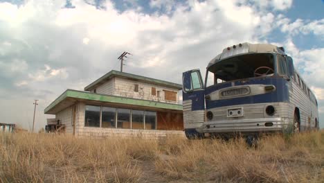 A-moving-time-lapse-shot-of-an-abandoned-Greyhound-bus-in-a-field-1