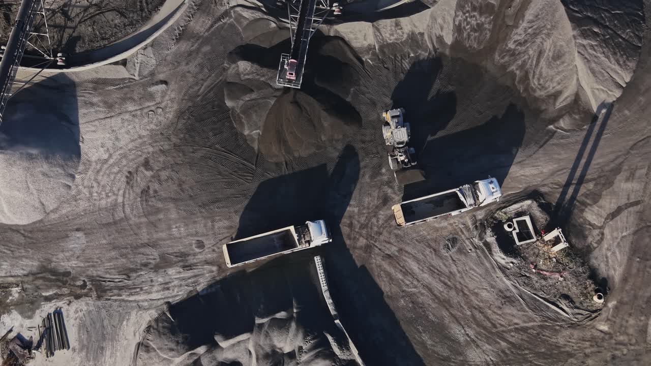 Quarry site showing trucks and mining equipment in operation