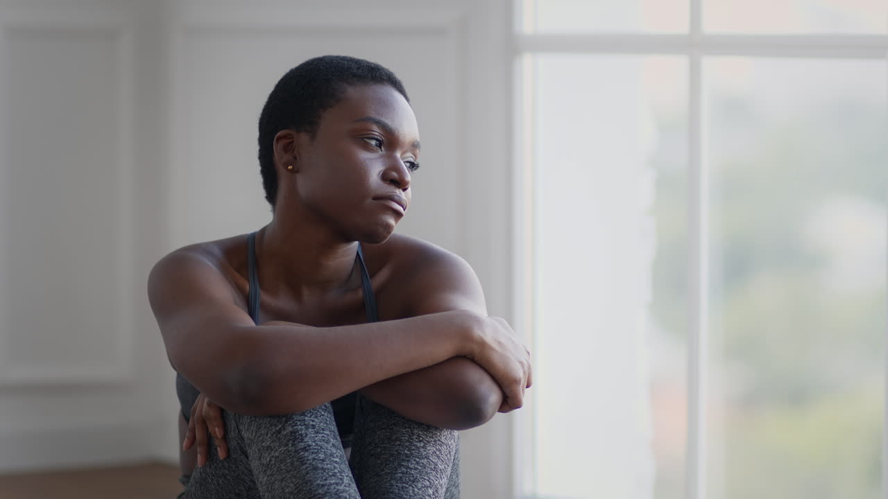 Thoughtful Woman Sitting by Window