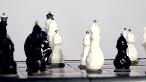 white and black chessfigures scattered around the board