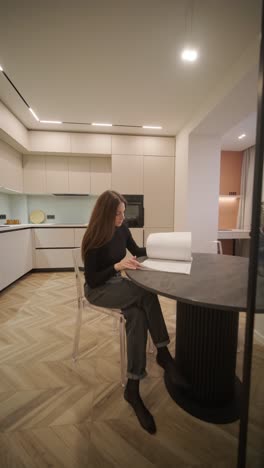 beautiful woman in a minimal style interior of modern contemporary white bright kitchen with natural light.