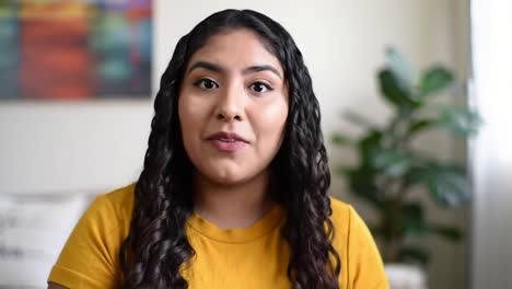 expressive young latina woman vlogging or on video call