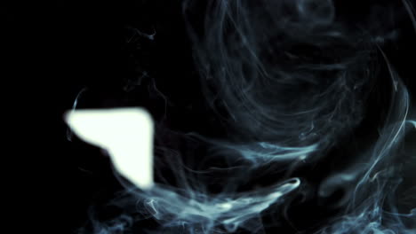 Smoke-rising-on-black-background