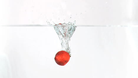 Strawberry-falling-into-water-in-super-slow-motion