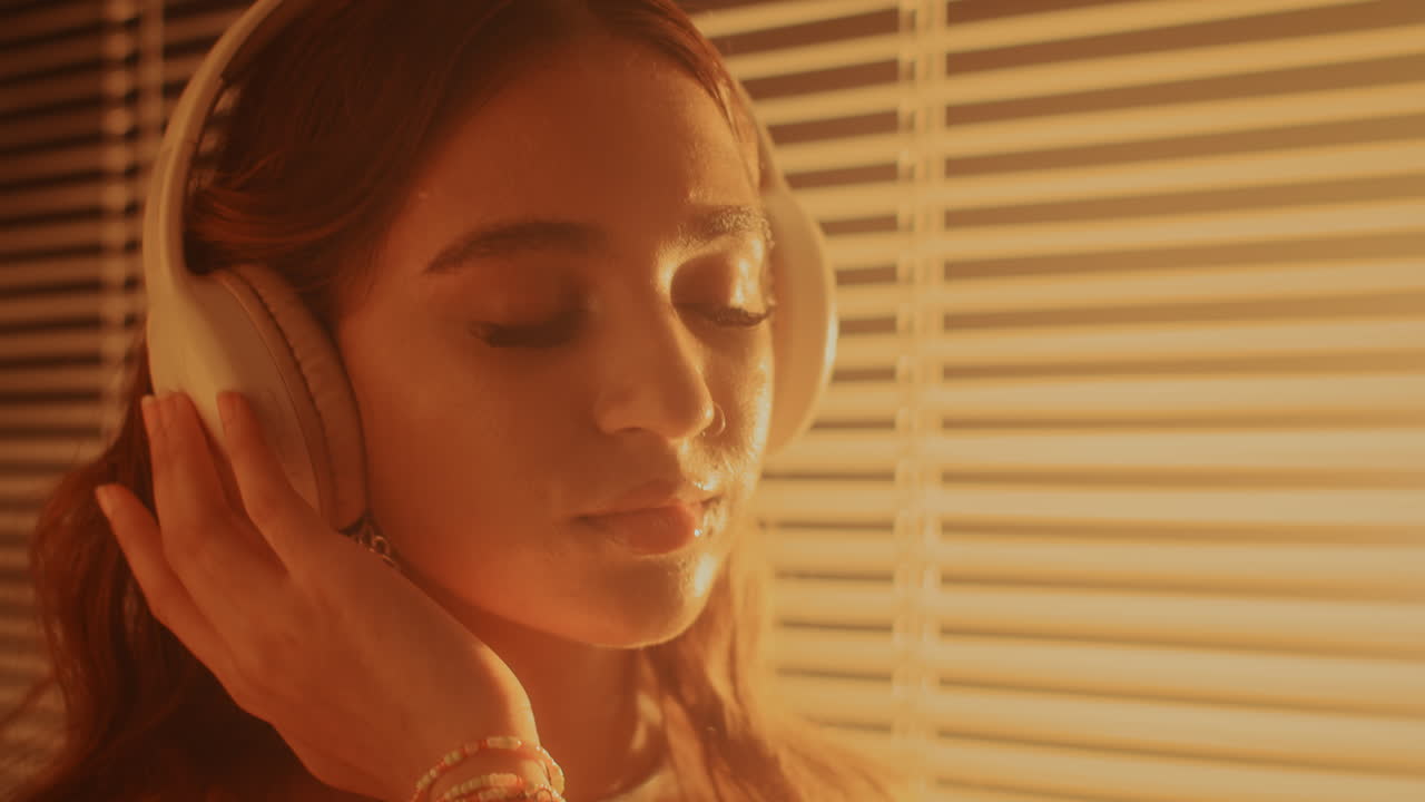 Woman with Eyes Closed Relaxing to Music in Headphones