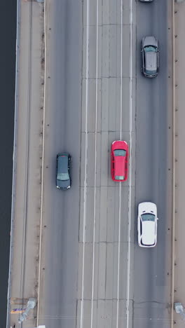 drone rotation. road junction and bridge on river in the city, aerial view. vertical video