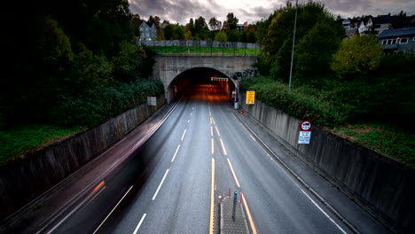 vehicles driving in evening, underpass, entrance and exit, tromso in norway. timelapse