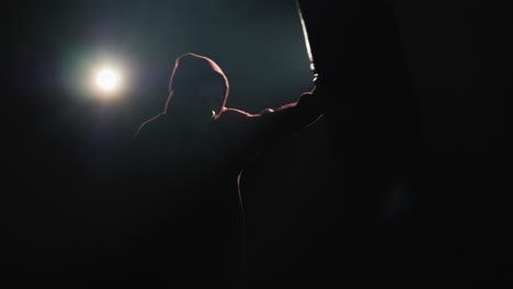 young fighter trains in a spotlight