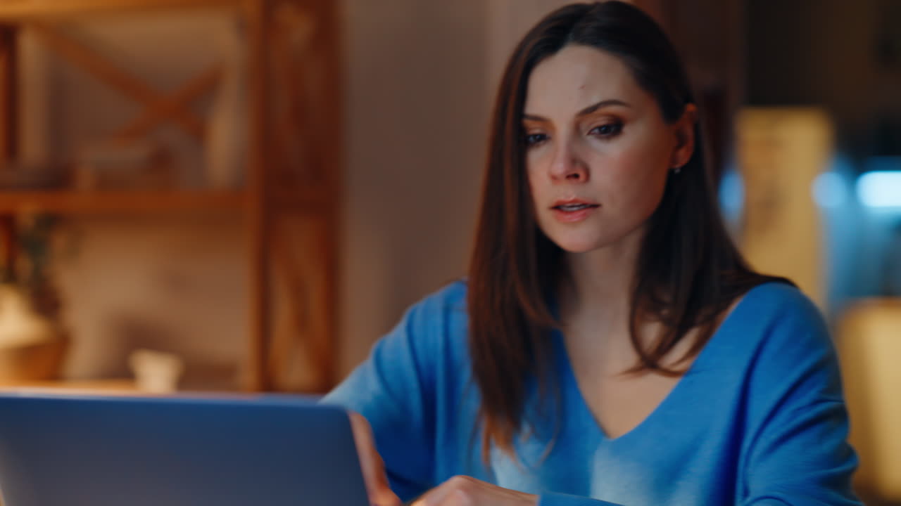 Angry businesswoman quarrelling video call at evening home office closeup