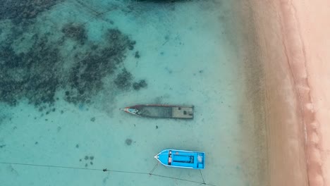 Lift-up-from-sunken-long-tail-boat-near-beach-on-cloudy-day-clear-water