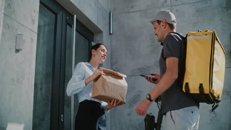 a customer receiving food delivery at her doorstep