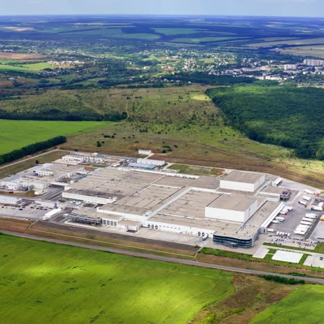 aerial view of modern industrial building surrounded by green fields. large modern production plant
