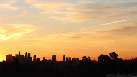 timelapse of sunrise downtown buildings in the distance