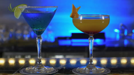 two pair of colorful drinks cocktail in cup glass fancy night club , fruite slice friendship celebrative party atmosphere