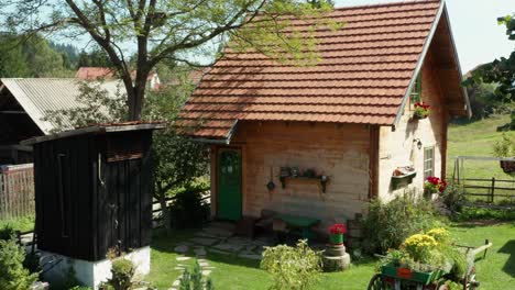 small wooden house cottage in rural area - aerial drone shot