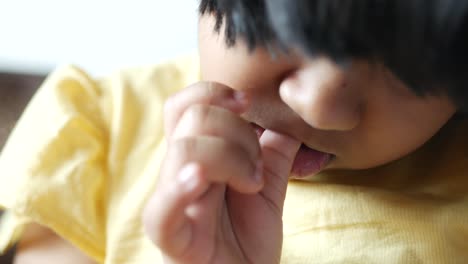 child girl biting her nails at home