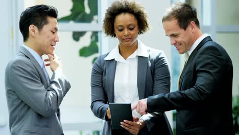 male female multi ethnic financial team using tablet