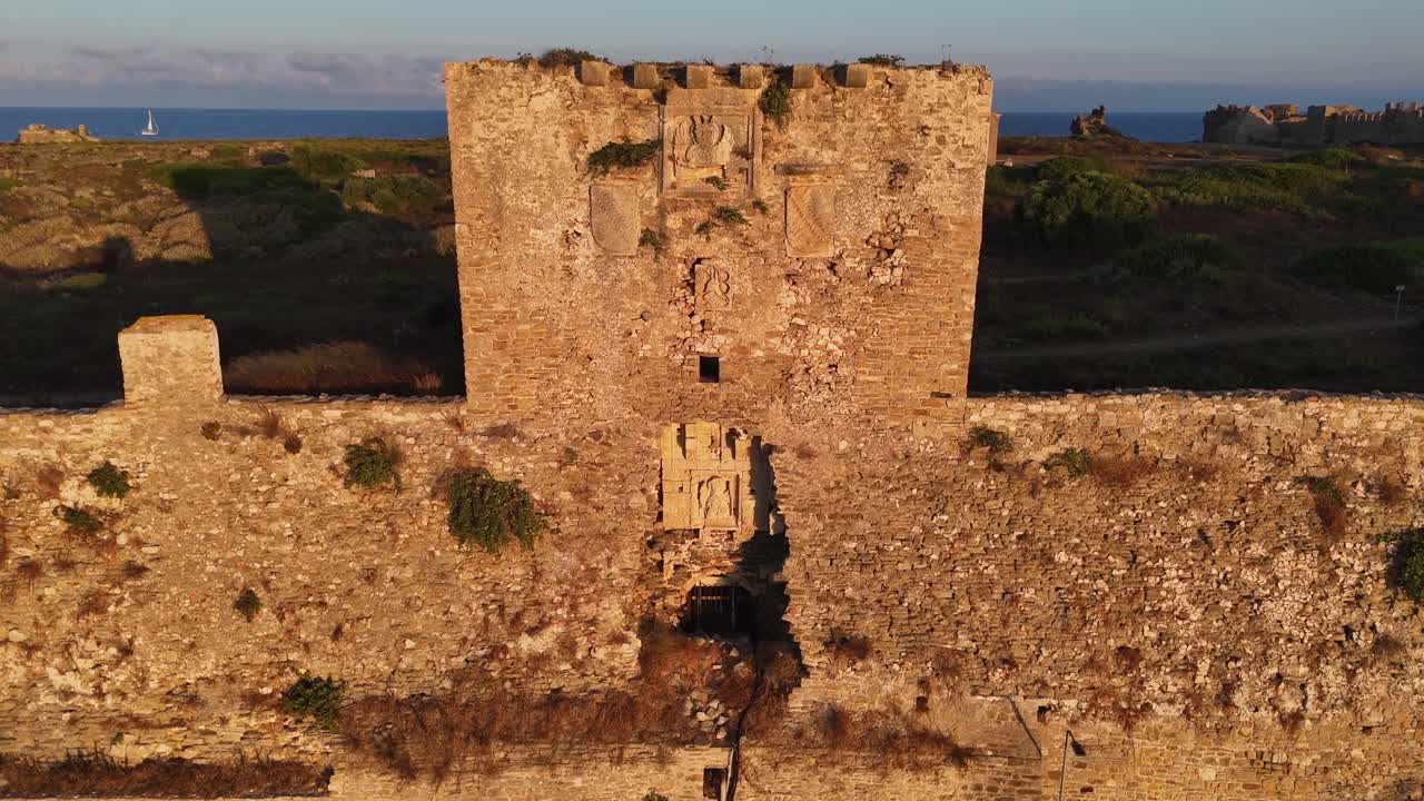 Methoni,Messenia,Peloponnese,Aerial view towards the Methoni Castle tower and close up detailed view of the tower during golden hour