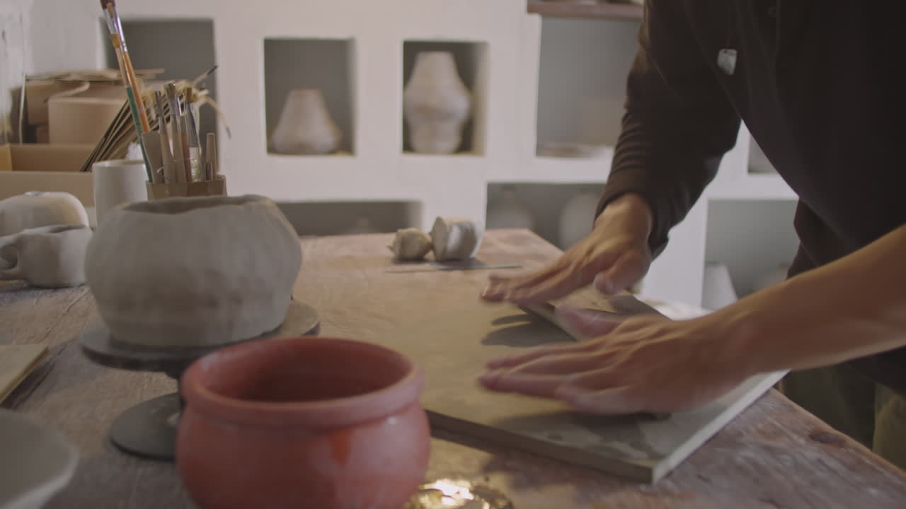 Ceramist Rolling Clay Coil at Worktop
