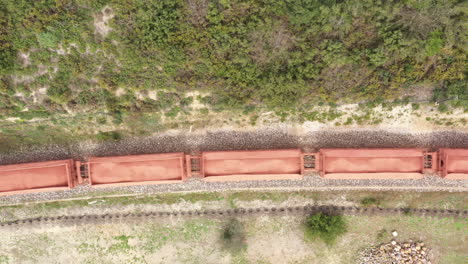 freight train aerial drone view over wagons with shipment on a railway