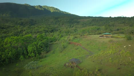 Rural-farmer-ranch-on-outskirts-of-tropical-jungle-in-Costa-Rica,-aerial