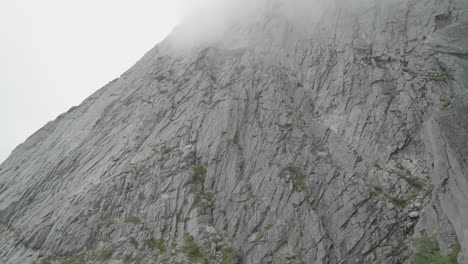 general view of a huge granite wall on a clouded day